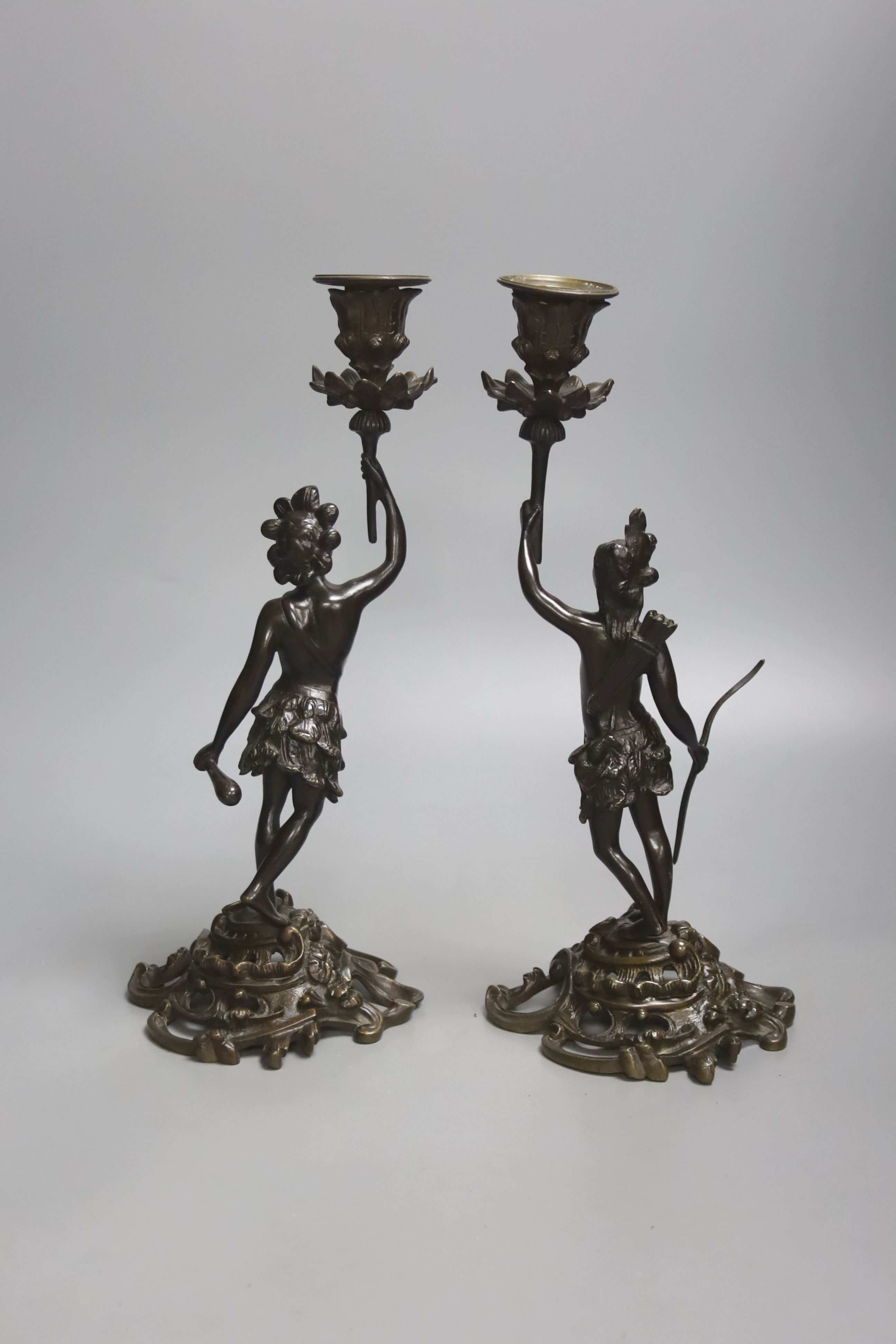 A pair of 19th century French bronze candlesticks, modelled as natives, height 32cm